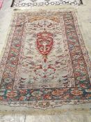 An antique Turkish? ivory ground rug, 218 cm long, 145 cm wide