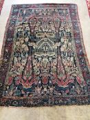 An antique Persian blue ground rug, woven with birds within a garden, 170 x 120cm