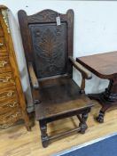 A 17th century style oak wainscot chair, width 54cm, height 122cm