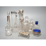 A collection of assorted mainly silver-capped scent bottles and toilet jars, etc. including two gilt