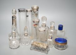 A collection of assorted mainly silver-capped scent bottles and toilet jars, etc. including two gilt