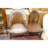 A brown leather upholstered desk chair, a mahogany hall chair and two upholstered armchairs