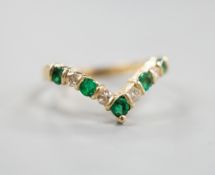 A modern 14k yellow metal, five stone emerald and four stone diamond set wishbone ring, size M,