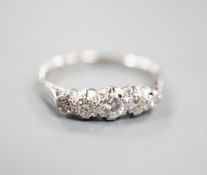 An 18ct & plat, graduated five stone diamond half hoop ring, size L/M, gross weight 2 grams.