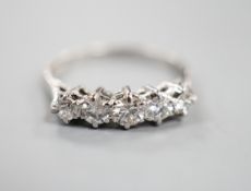 An 18ct white metal and graduated five stone diamond ring, size P/Q, gross weight 2.9 grams.