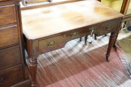 A Victorian mahogany writing table fitted three frieze drawers and turned tapering legs on