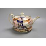 A Chamberlain teapot cover and stand painted with an Imari pattern, c.1810, 26cm long