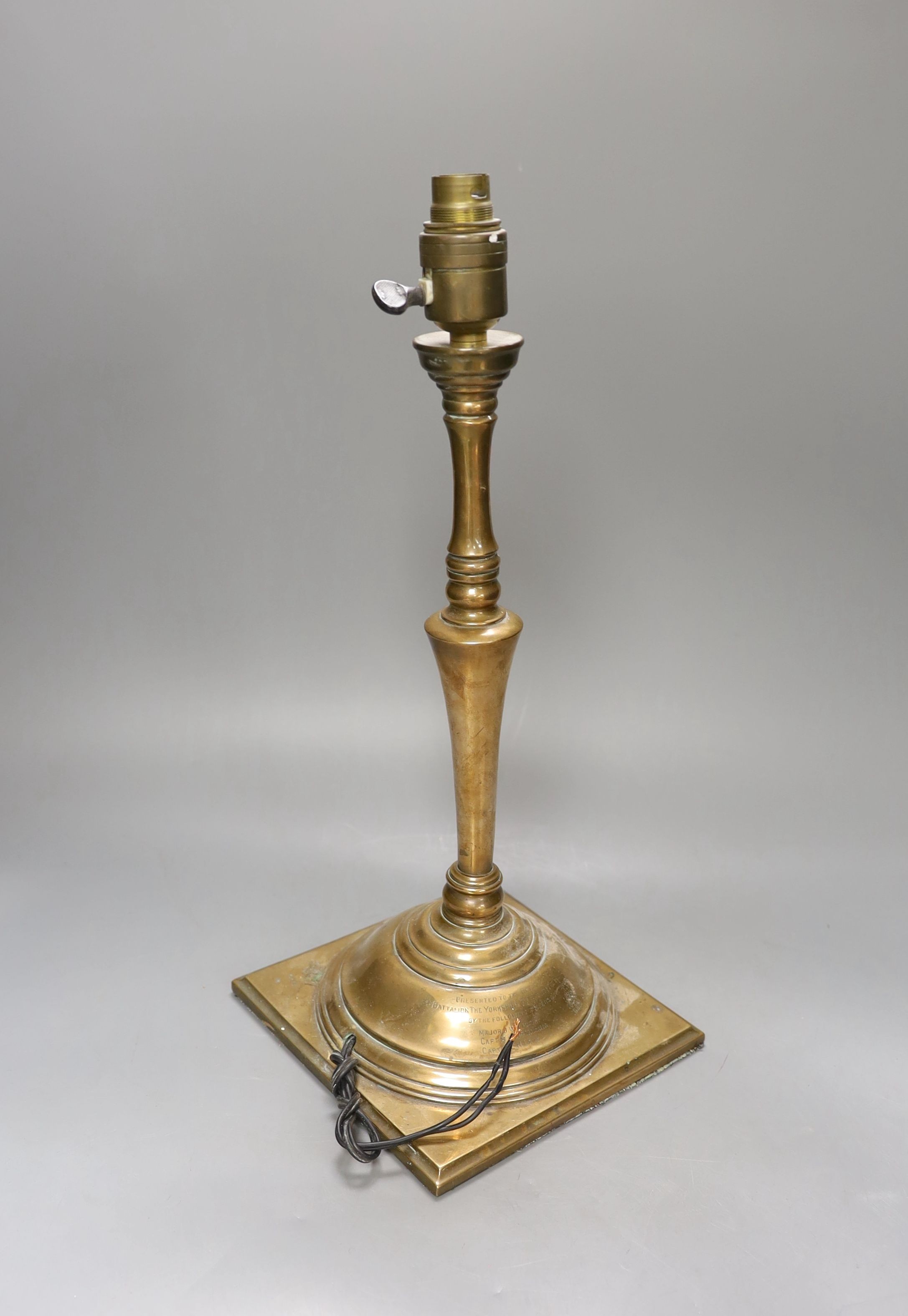 A late Victorian copper alloy table lamp, engraved inscription ‘presented to the officers mess of