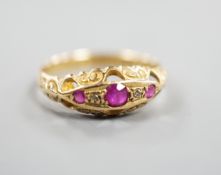 A George V 18ct gold three stone ruby and two stone diamond chip set ring, size Q, gross weight 3