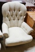 A pair of Liberty of London Victorian style button back armchairs with mahogany legs and brass