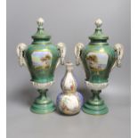 A pair of early 20th century Dresden vases painted with landscapes on an avocado green ground,