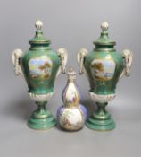 A pair of early 20th century Dresden vases painted with landscapes on an avocado green ground,