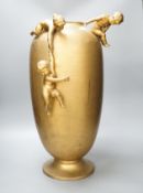 A large Kayser gilt metal ovoid jar, with playful cherubs, 55cm.