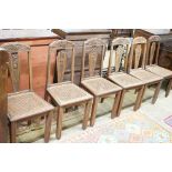 A set of six Continental Art Deco carved and stained beech salon chairs with caned seats, width