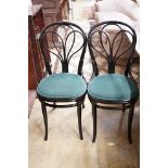A set of four Thonet ebonised bentwood dining chairs, upholstered seats, stamped mark