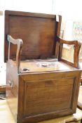 An early 19th century mahogany box commode with folding top and bone handled brass pump handle,