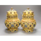 A pair of Zsolnay Pecs Persian inspired vases and covers, 27 cms high.