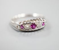 A George V 18ct white gold three stone ruby and two stone diamond ring, size P/Q, gross weight 2.3