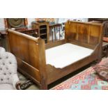 A 19th century Continental Gothic Revival mahogany sleigh bed, 209 cm long, 126 cm wide