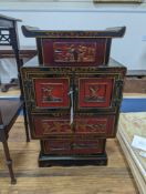 A late 19th century Chinese red and black lacquered cabinet, width 39cm, height 66cm