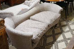 A Victorian upholstered settee with turned walnut legs, fitted brass castors, length 188cm