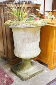 A reconstituted stone campana garden urn decorated with classical figures, height 86cm, diameter