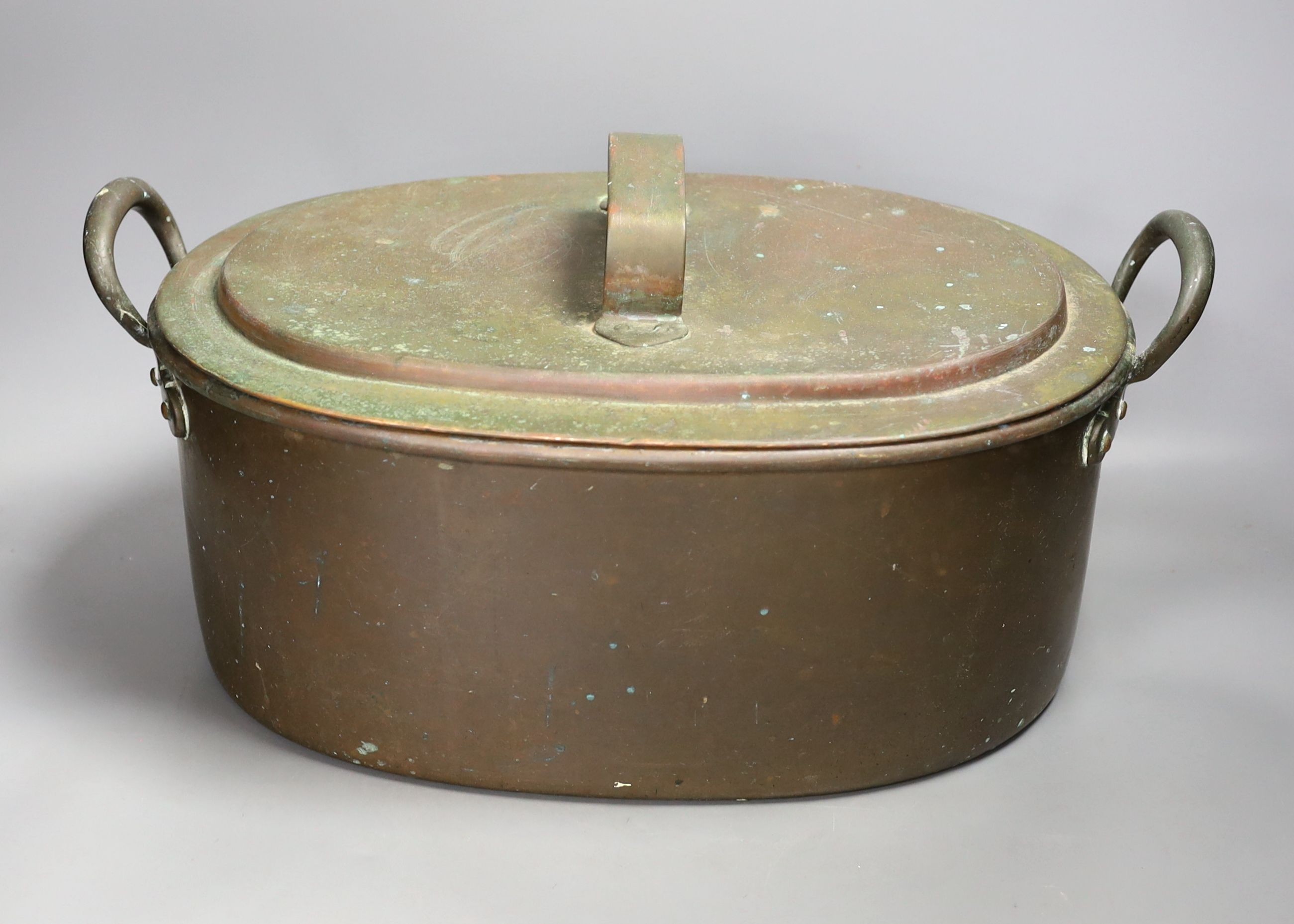 A Victorian oval copper two handled preserve pan and cover.35cms wide.