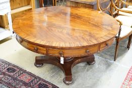 An early Victorian flame mahogany drum top ‘rent’ table, fitted four drawers on turned column