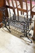 A group of wrought iron fireside effects including a pair of dogs, basket, 54 cm wide etc.