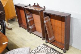 A set of three Regency mahogany open bookcases with beaded borders and fluted bun feet, one with