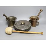 Two pestles and mortars and a Chinese gong with beater, gong 21 cms wide.