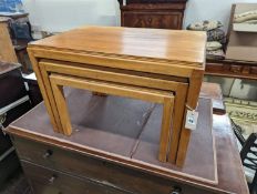 A nest of three Gordon Russell 1960's rectangular teak tea tables, width 68cm, depth 45cm, height