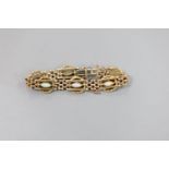 An Edwardian yellow metal and six stone navette shaped white opal set bracelet, with safety chain,