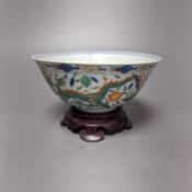 A Wucai bowl, dragon and flamingo pearl decoration, Jiaqing mark, on wood stand. 16cm diameter