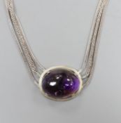 A white metal and large cabochon oval amethyst set triple strand necklace, 47cm