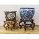 Two Chinese fish bowls on stands, tallest 51 cms including stand.