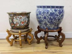 Two Chinese fish bowls on stands, tallest 51 cms including stand.
