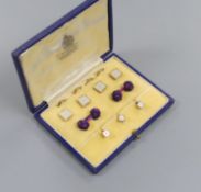 A modern cased seven (ex 9) piece 9ct gold, mother of pearl and seed pearl set dress stud set, gross