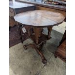 An early 20th century circular oak tripod book table, diameter 60cm, height 69cm