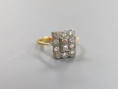 A 1920's yellow metal and diamond cluster set tablet ring, size F, gross weight 2.3 grams.