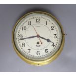 A Mercer brass bulkhead timepiece, 25 cms wide.