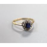 An early 20th century yellow metal, sapphire and diamond set oval cluster ring, size I/J, gross