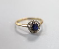 An early 20th century yellow metal, sapphire and diamond set oval cluster ring, size I/J, gross