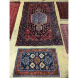 A Hamadan blue ground floral rug and a smaller Caucasian design blue ground rug, larger 210 x 130cm