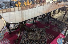 A reproduction George III style rectangular mahogany extending dining table, 241cm extended, one