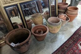 A collection of approximately 20 assorted terracotta garden planters, largest diameter 35cm