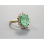 A modern 14k yellow metal, emerald and diamond set oval cluster ring, size M, gross weight 5.9