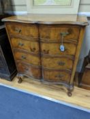 A 1920's Queen Anne revival banded walnut shaped front chest, width 76cm, depth 46cm, height 85cm