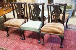 A set of twelve early 20th century Chippendale revival carved mahogany dining chairs including two