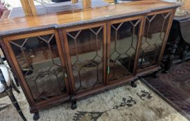 A 1920's Chippendale revival glazed mahogany break front dwarf cabinet, width 160cm, depth 43m,